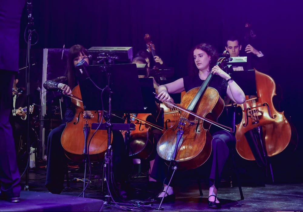 String section of Theatrical Symphony musicians rehearsing together